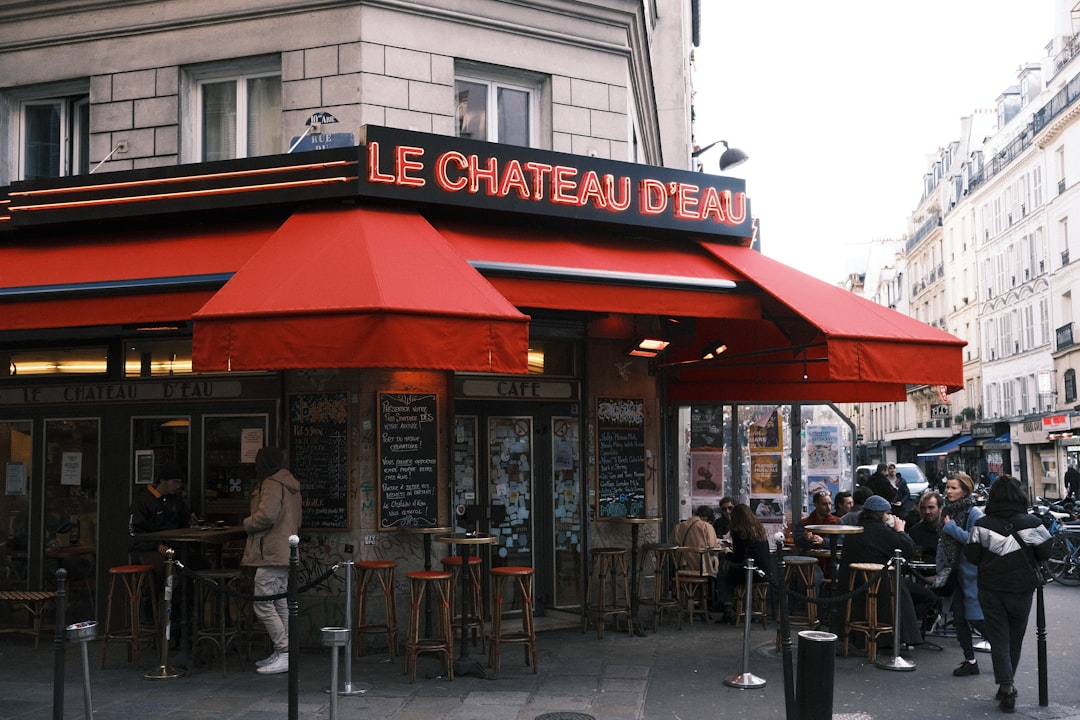 a group of people outside a restaurant, Le Chateau d