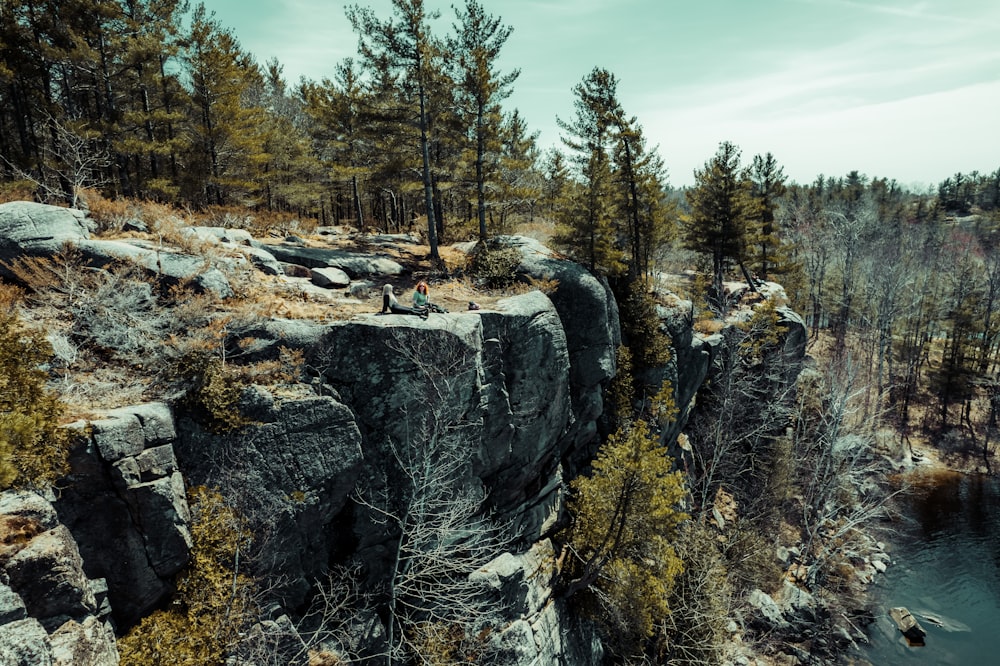 a group of people climbing a rock