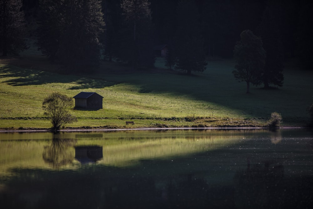 a small house by a lake at night