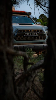 Toyota offroad vehicle with a BMW motor adapter plate, captured from a side angle in natural light.