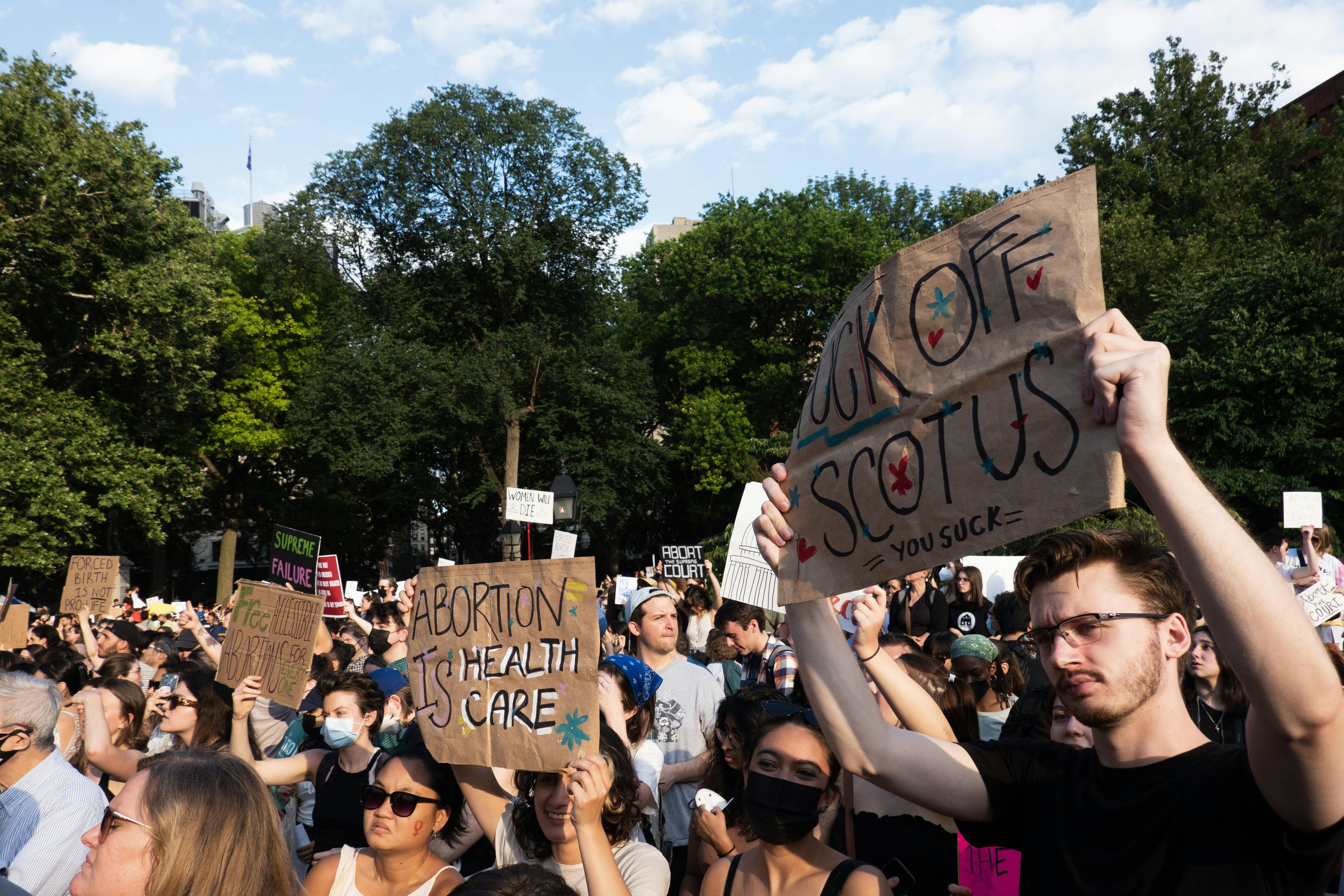 a crowd of people holding signs