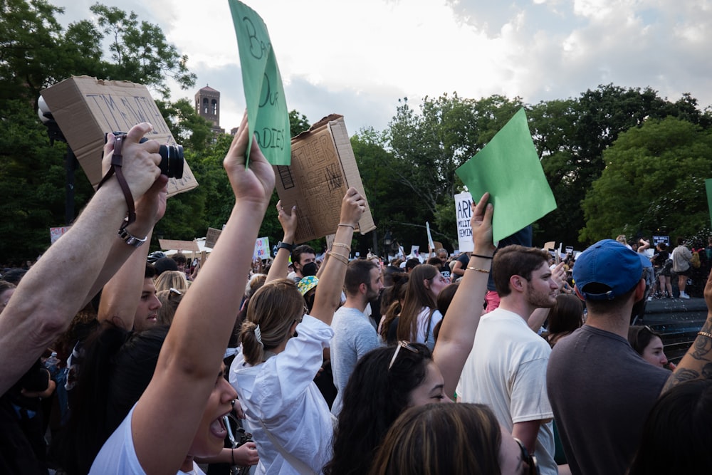 a crowd of people holding up signs