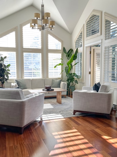 A bright, modern living room showcasing a harmonious blend of sleek furniture and warm natural light.