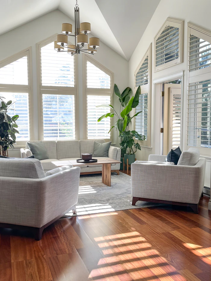 Living room with tall white plantation shutters
