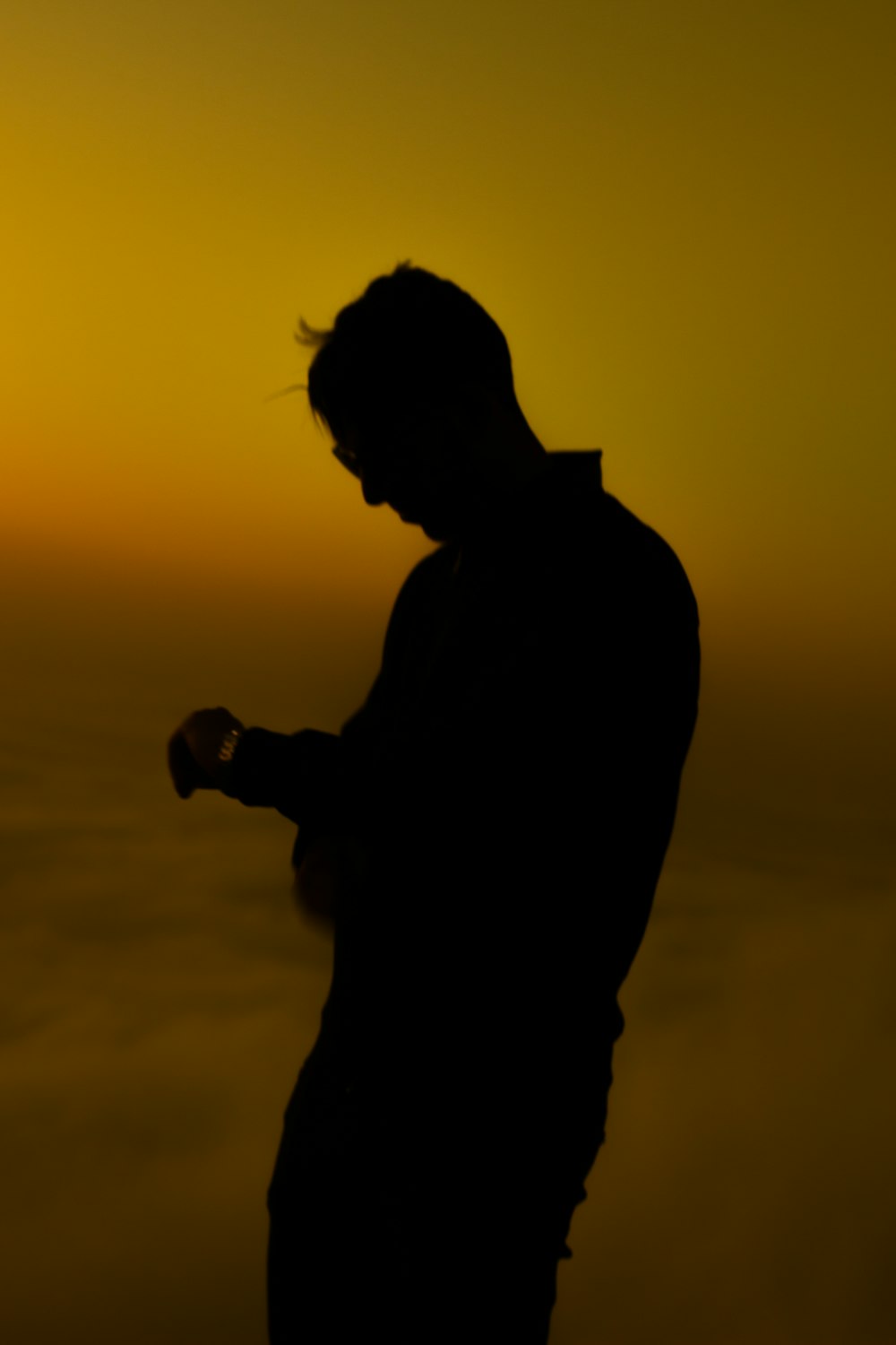 silhouette of a man holding a gun