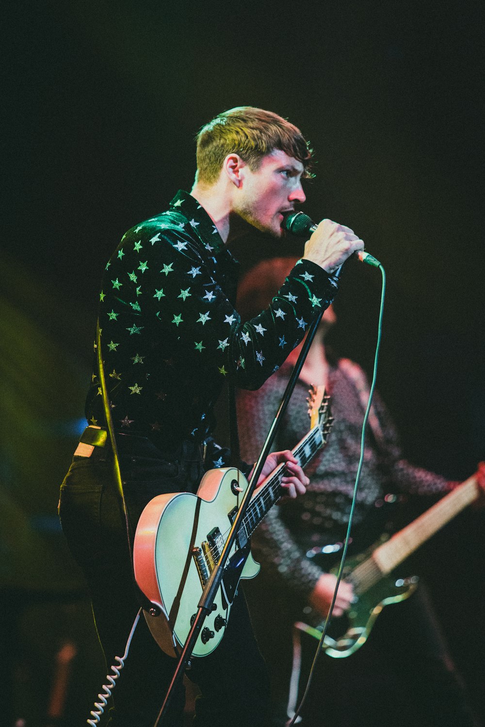 a man singing into a microphone