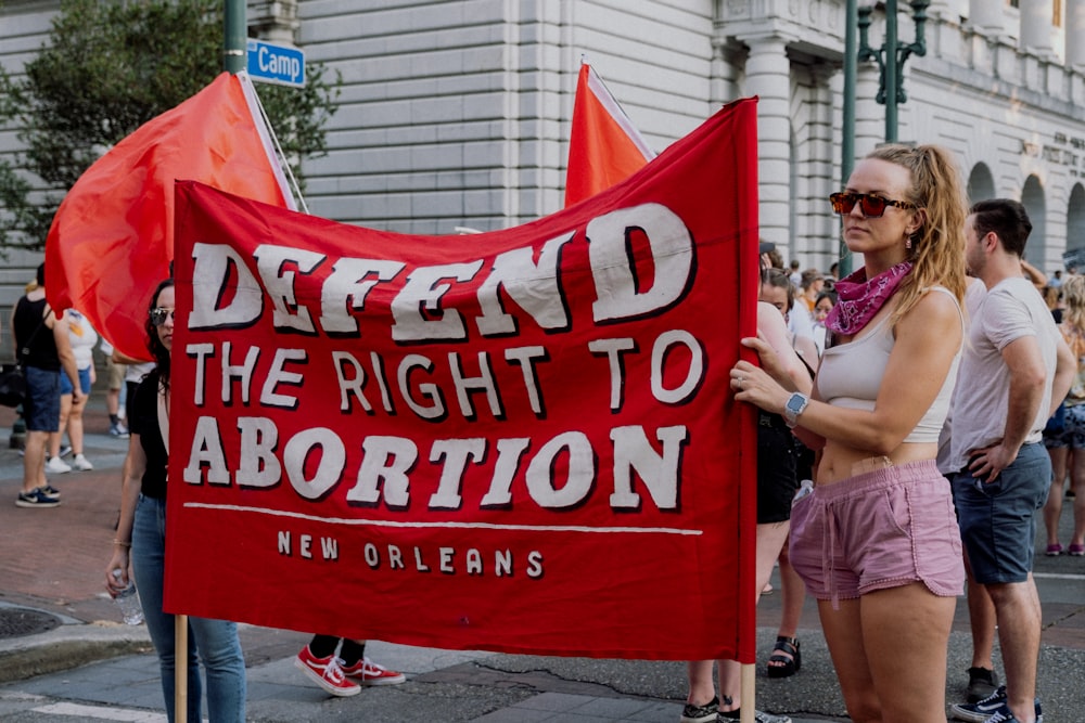 a woman holding a sign