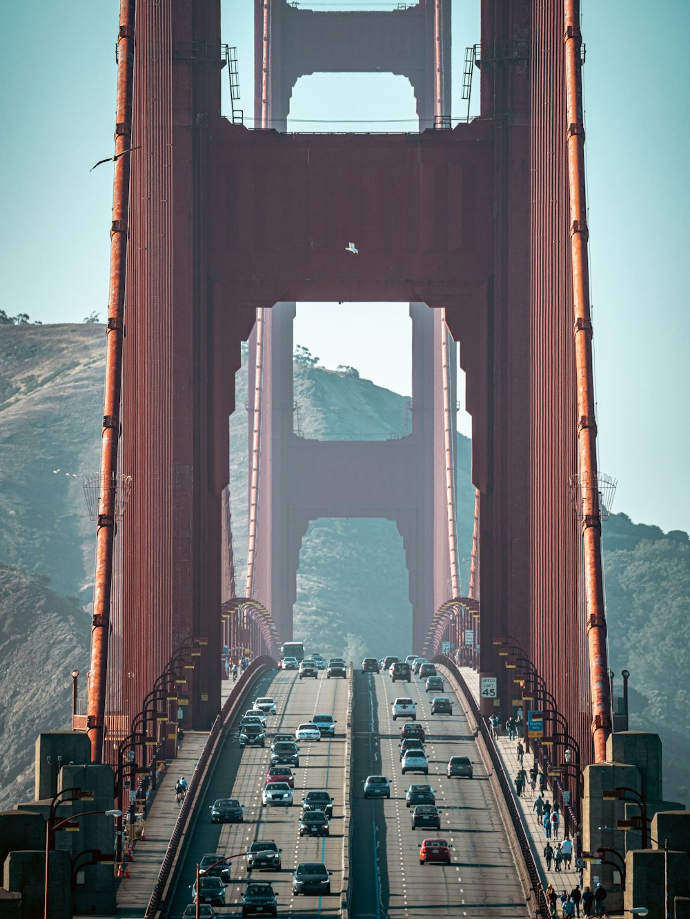 a large red bridge with cars on it