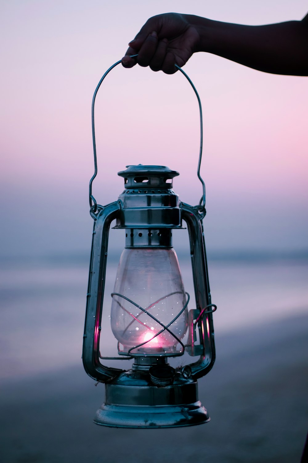 a hand holding a light bulb