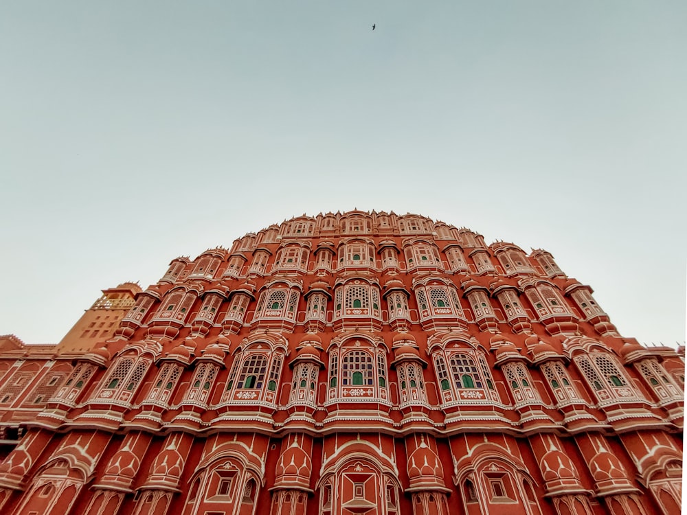 a large building with many arches with Hawa Mahal in the background