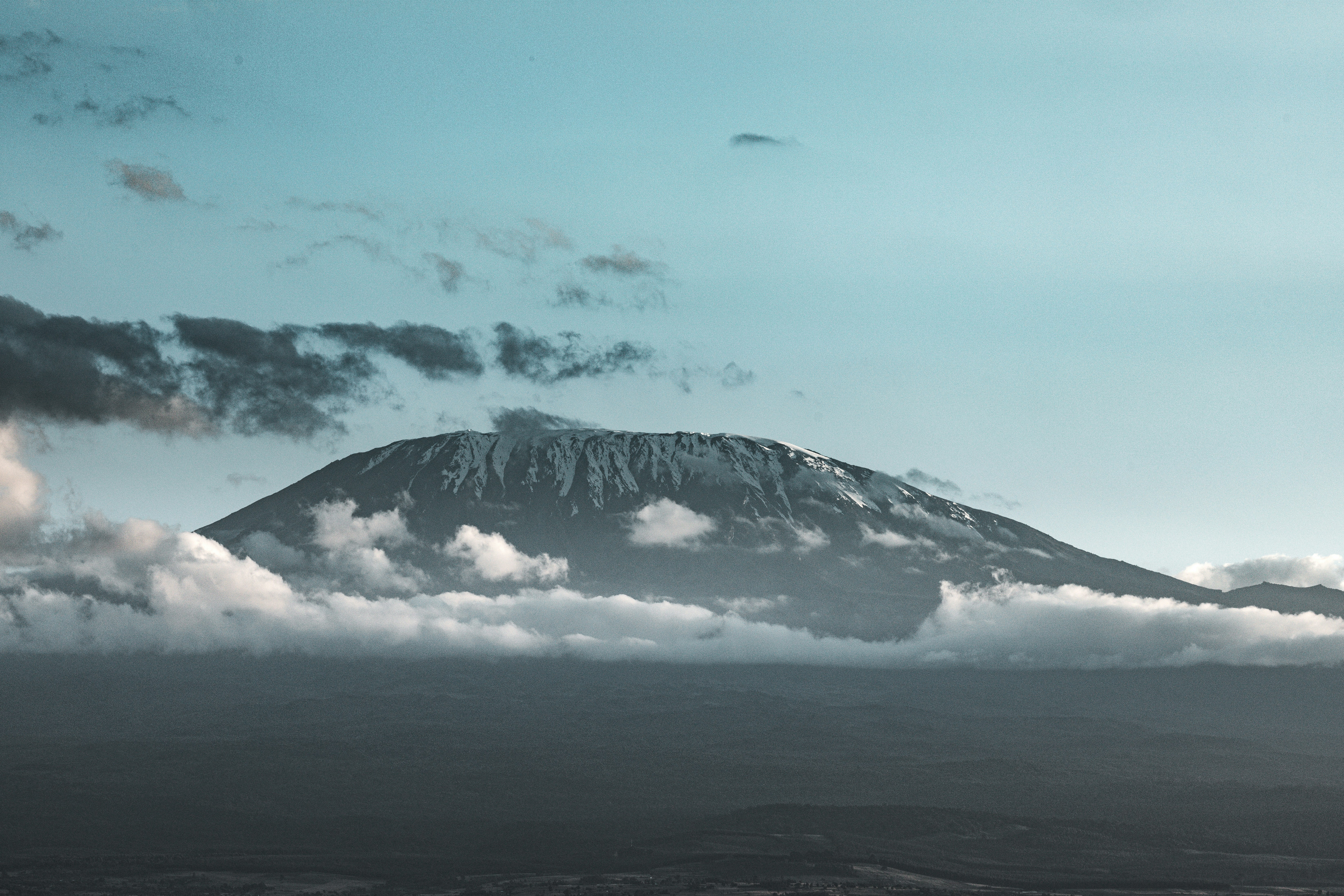 A mountain covered in clouds photo – Free Blue Image on Unsplash