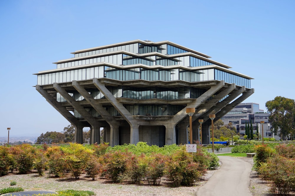 a building with a walkway and bushes