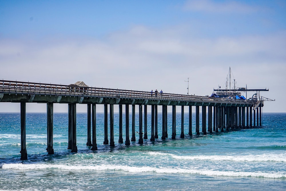 a long pier with people walking on it