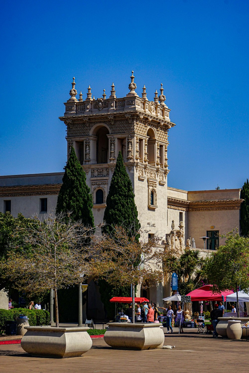 a building with a tower and trees in front of it