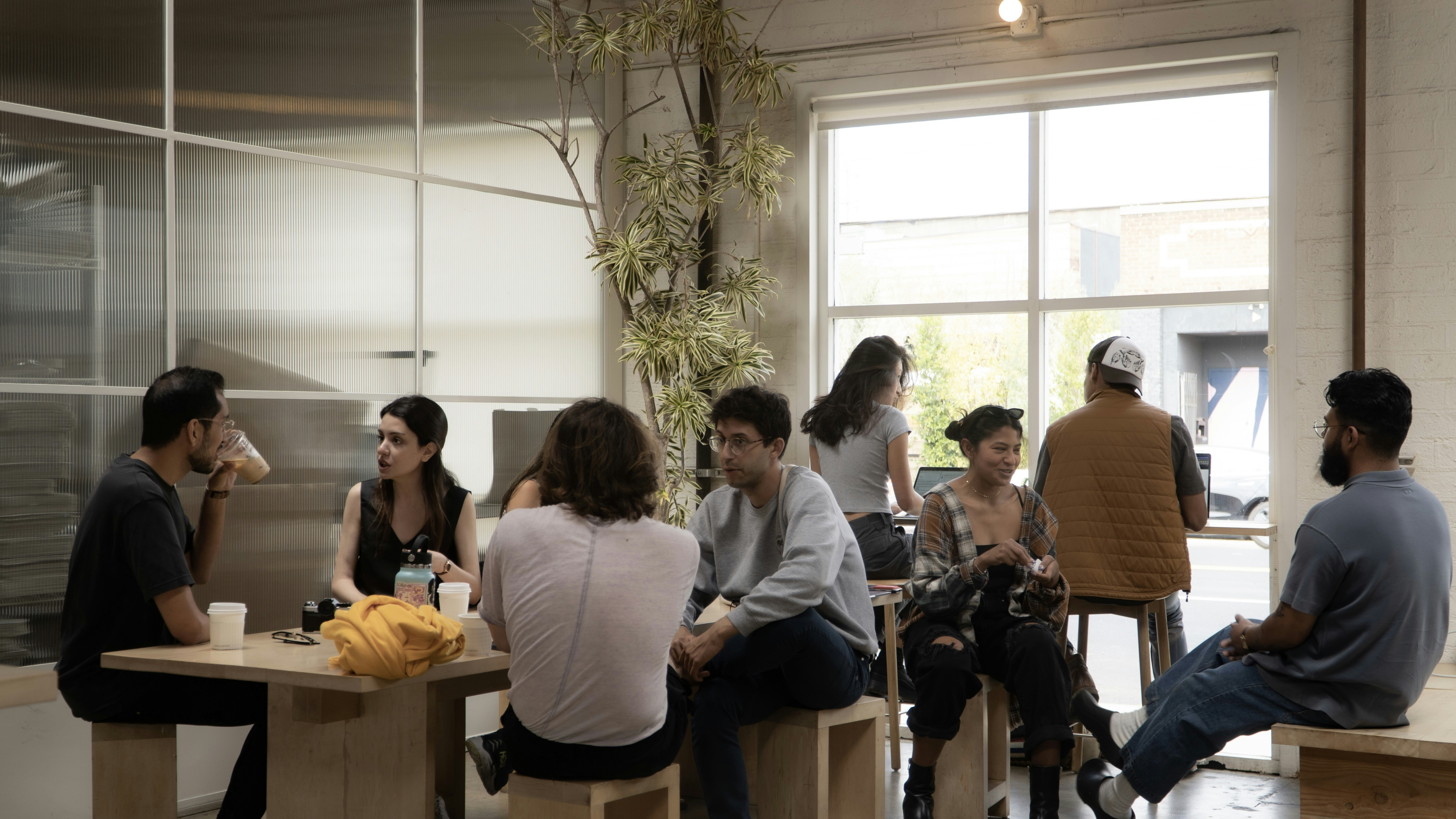 a group of people sitting around a table, 