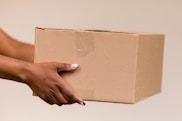 a hand holding a box