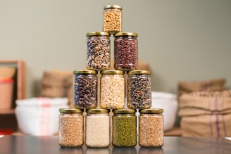 Packets of different types of rice and flours stacked in a clean pantry setting.