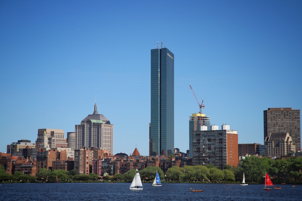 a city skyline with sailboats