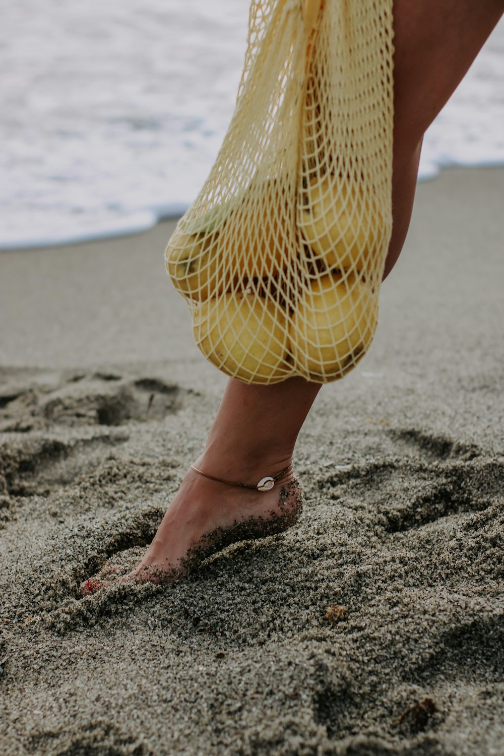 a woman's feet in the sand