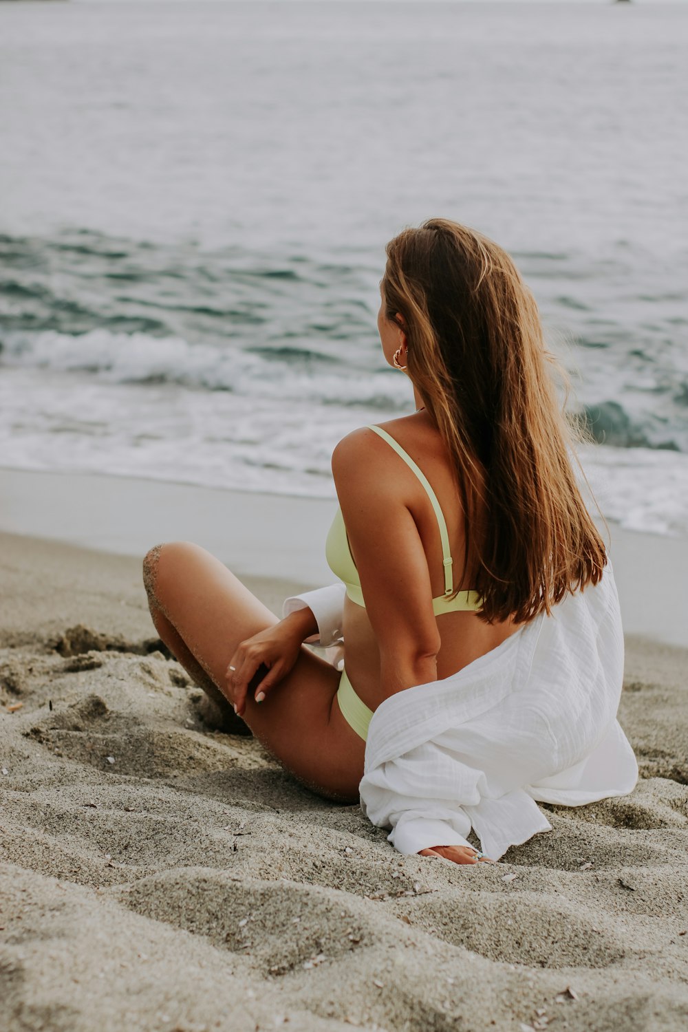 a woman sitting on a beach