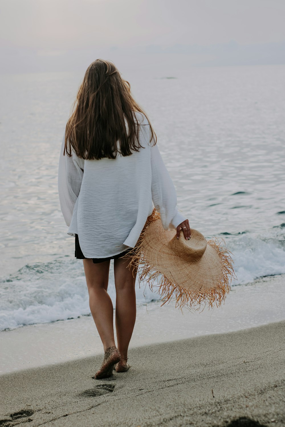 a woman walking on a beach