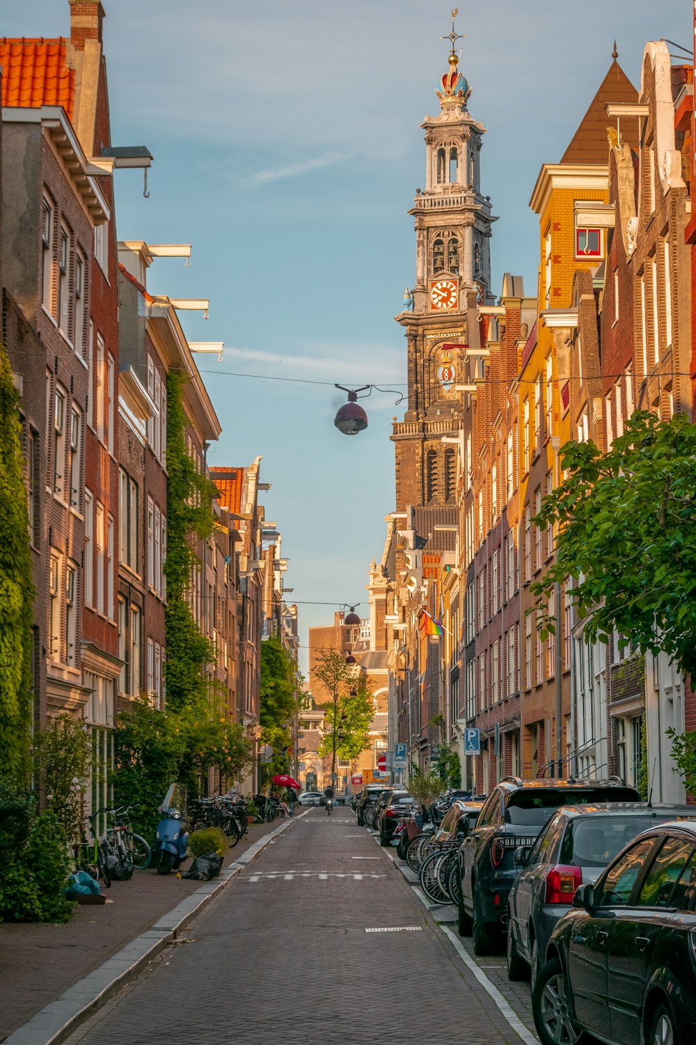 a narrow city street with buildings in the background