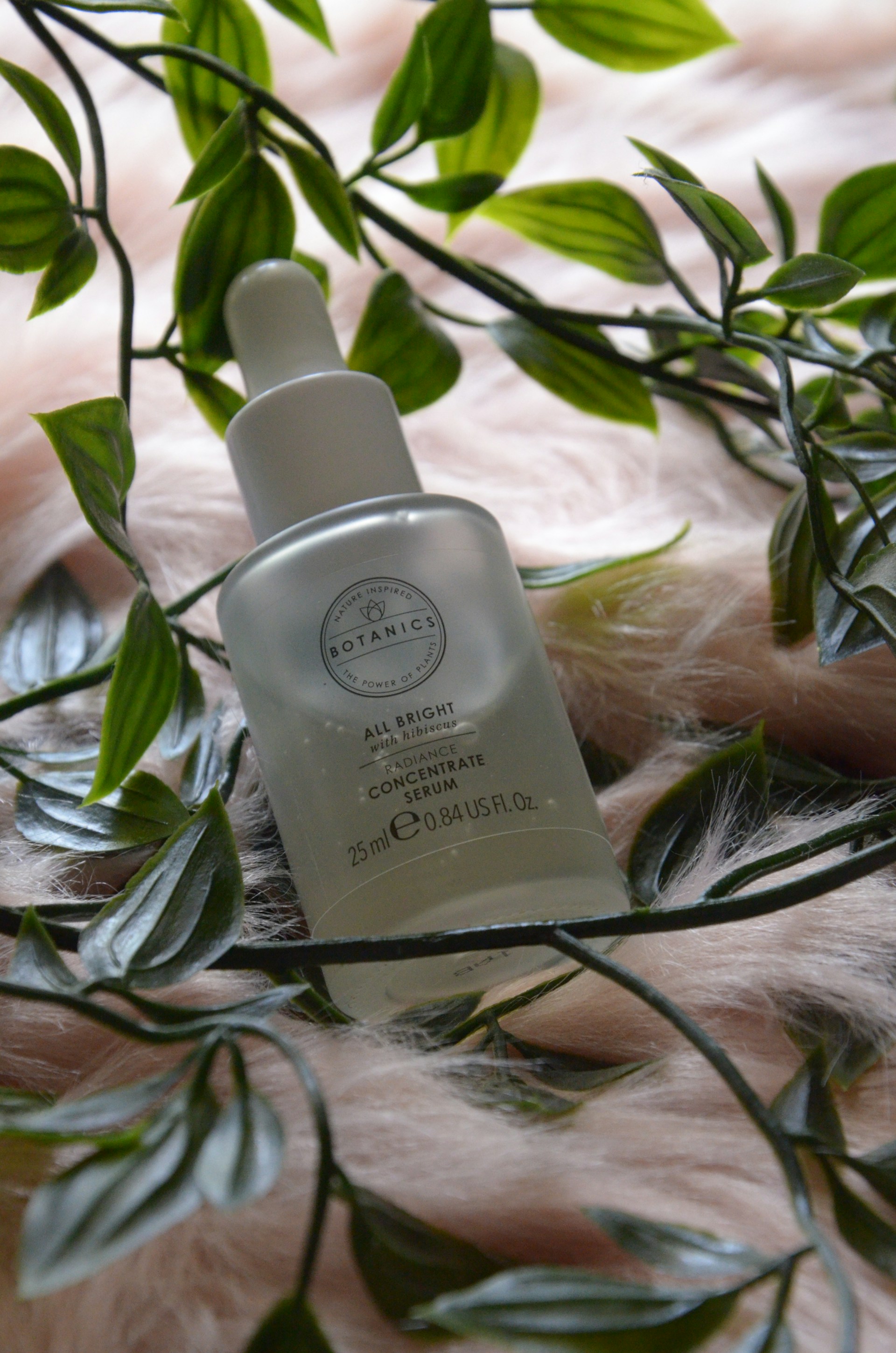 a bottle of perfume on a plant