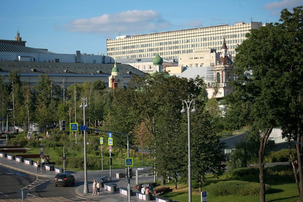 a street with trees and buildings in the background