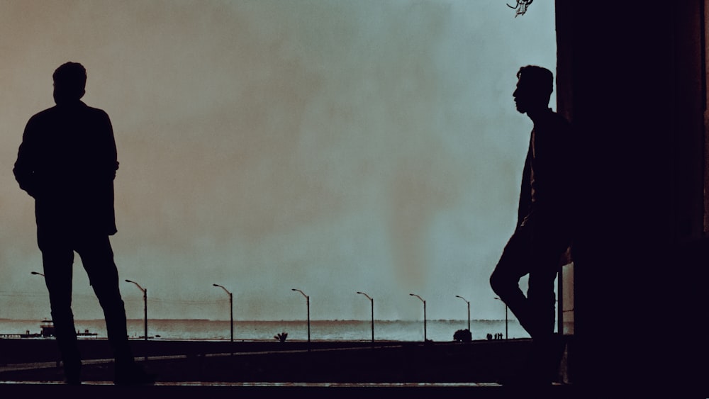 a man and a woman walking on a sidewalk