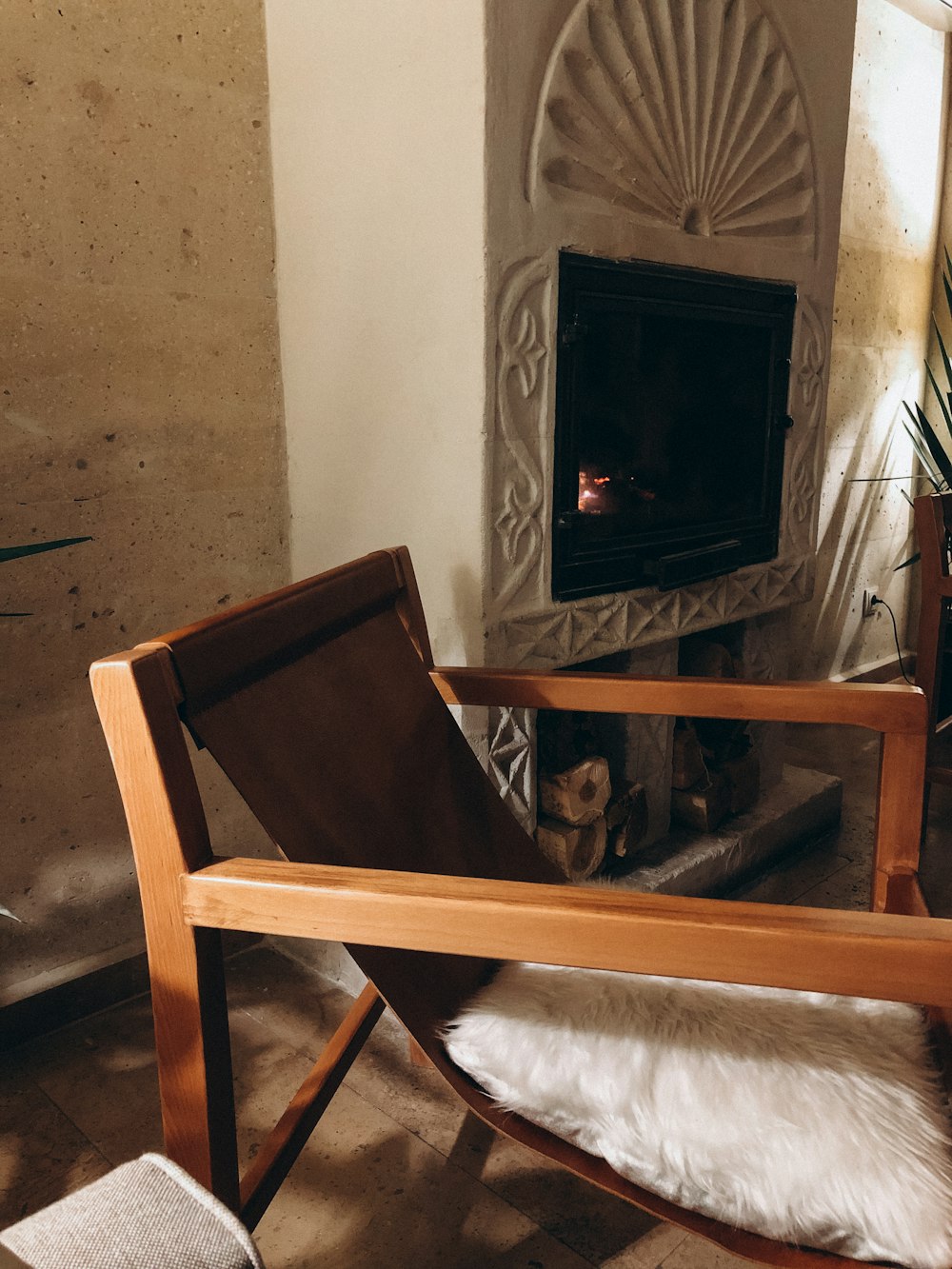 a chair in front of a fireplace