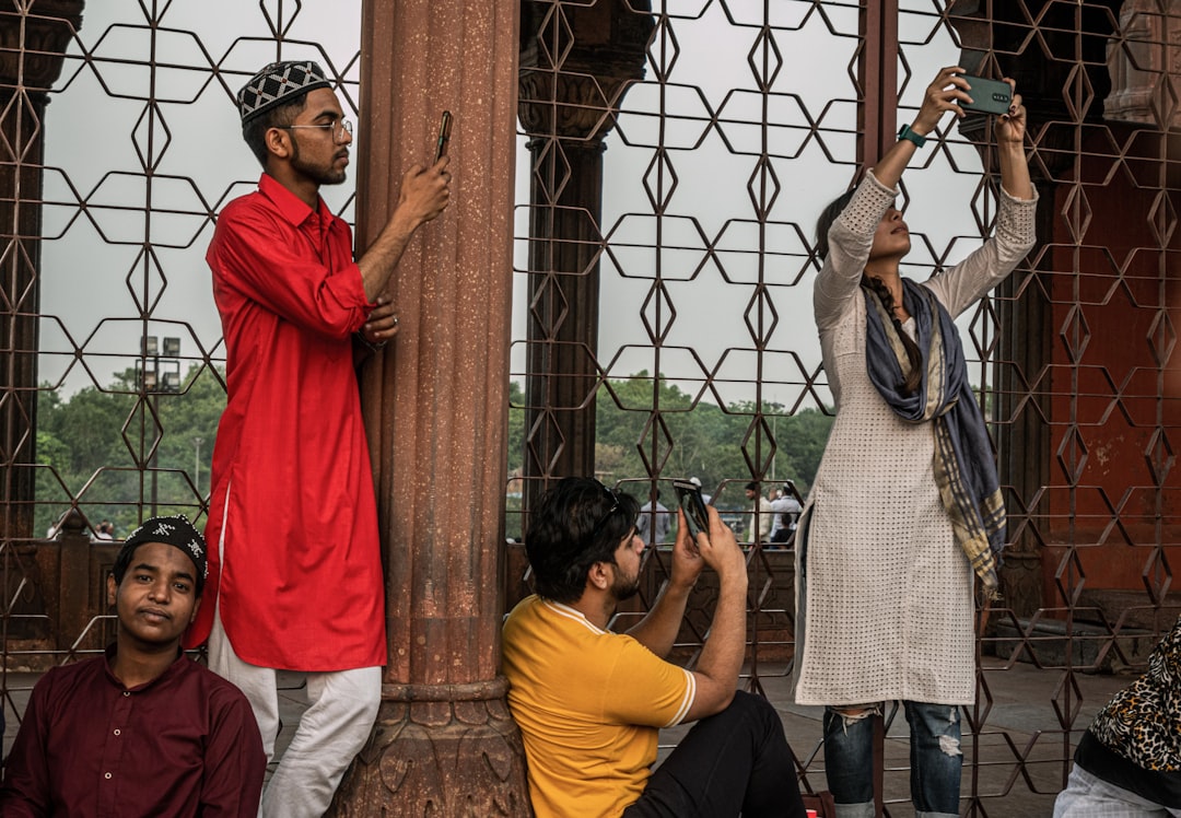 a man taking a picture of a woman holding a camera,