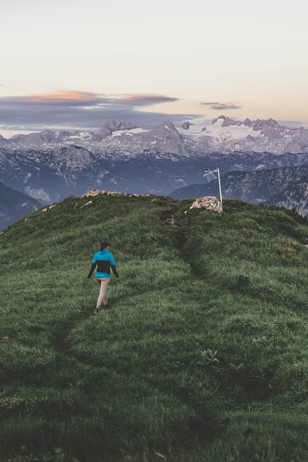 a person walking on a grassy hill