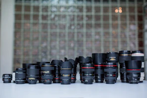 A collection of various lenses neatly arranged on a table, showcasing options for different filming needs.