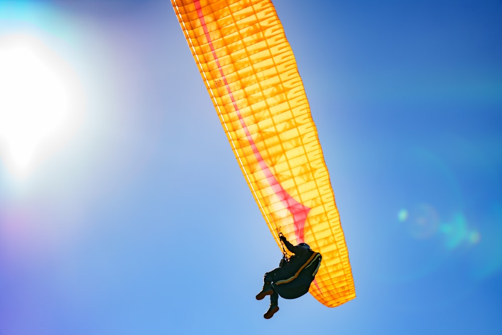 a person in the air with a parachute