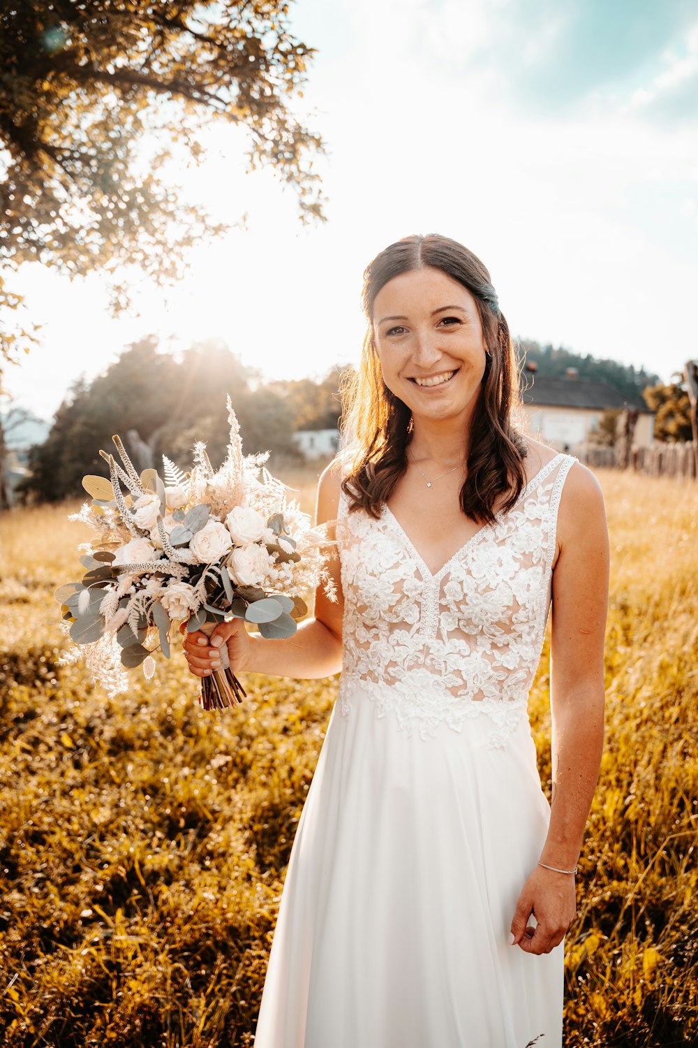 a person in a white dress holding flowers