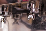 Close-up of the shiny copper parts being restored on an espresso machine.