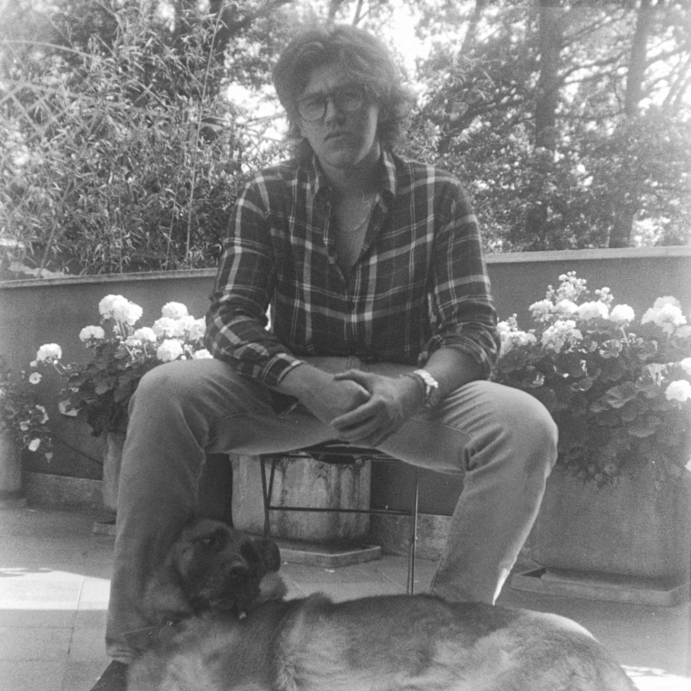 a man sitting on a bench with a dog