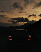 Artistic shot of Mazda CX-8’s silhouette against a dusk sky with city lights