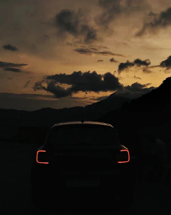 Artistic shot of Mazda CX-8’s silhouette against a dusk sky with city lights