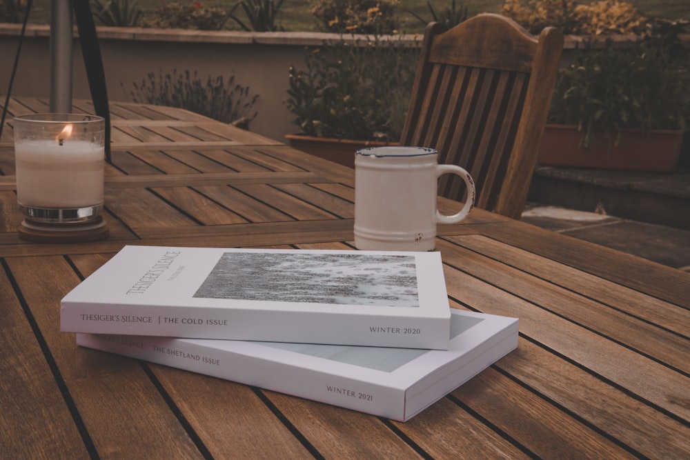 a book and a glass of milk on a table