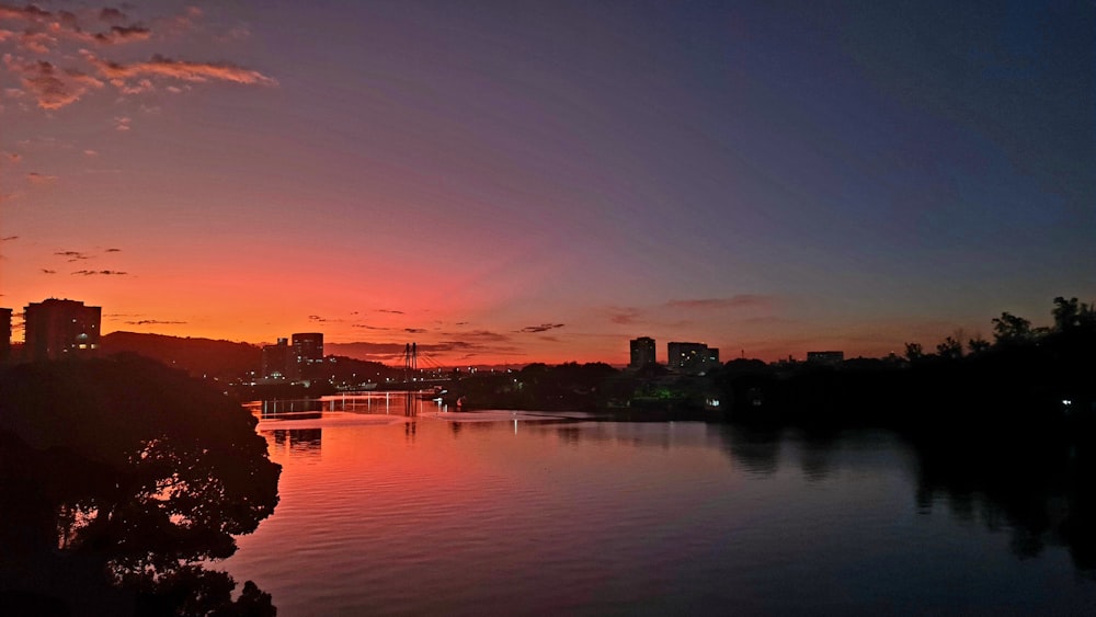 a body of water with buildings and trees around it