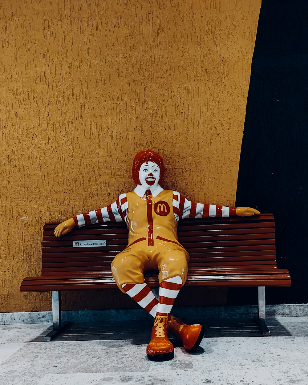 a clown sitting on a bench