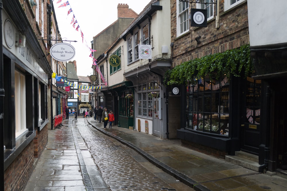 a wet street with people walking on it