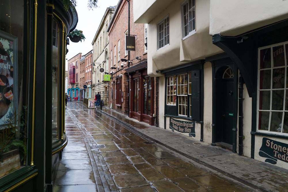 a wet street with buildings on both sides