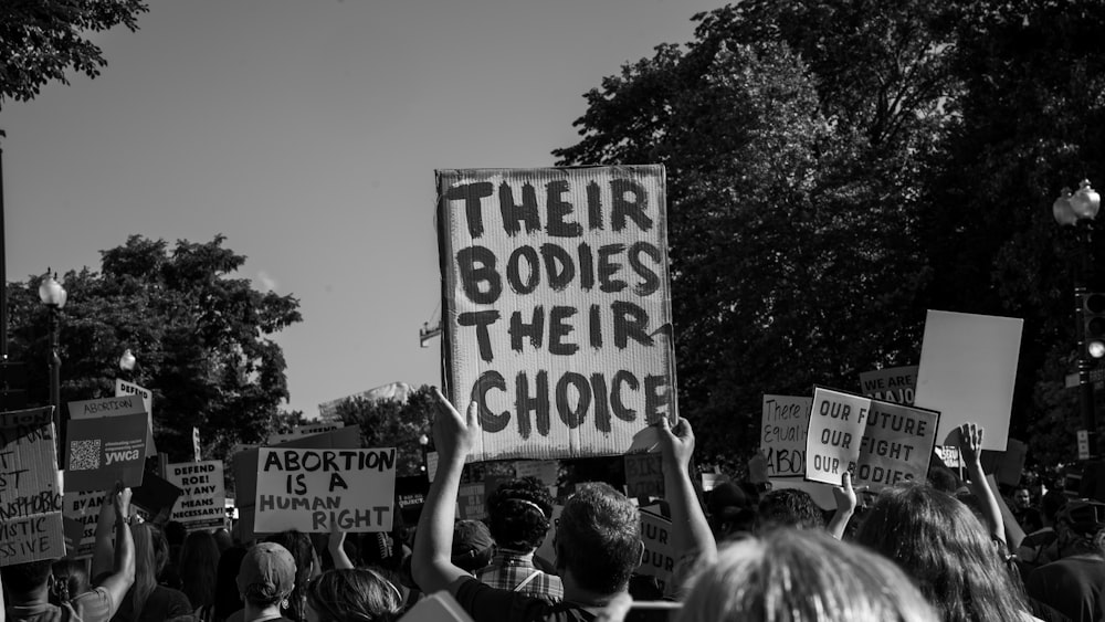 a group of people holding signs