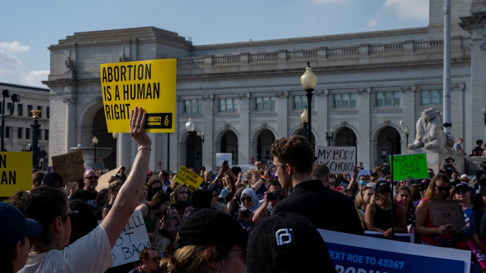 a crowd of people holding signs