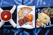 A colorful traditional African meal beautifully arranged on a wooden table.