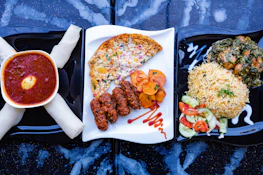 A colorful traditional African meal beautifully arranged on a wooden table.