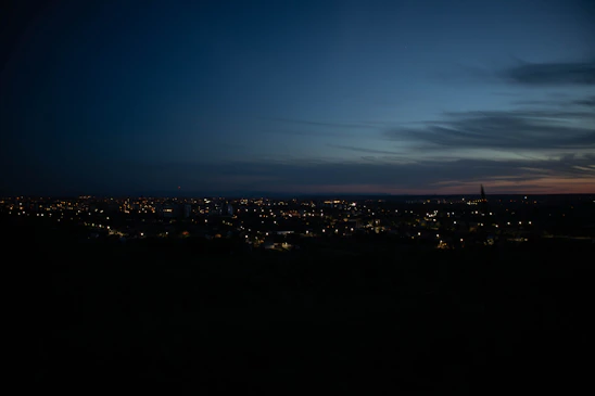A serene cityscape at dusk with glowing streetlights symbolizing data and connectivity flowing through the urban landscape.