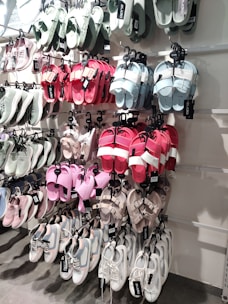 An over-the-door shoe organizer hanging on a white door, packed with colorful sneakers and boots.